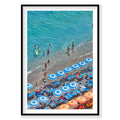 Aerial view of Positano beach with blue and yellow umbrellas, swimmers and turquoise water, photography print by Remy Gerega