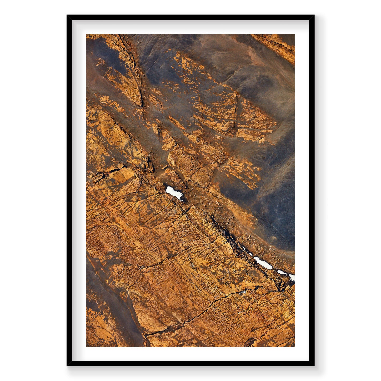 Aerial view of golden Icelandic mountains with snow patches from above, photography print by Remy Gerega