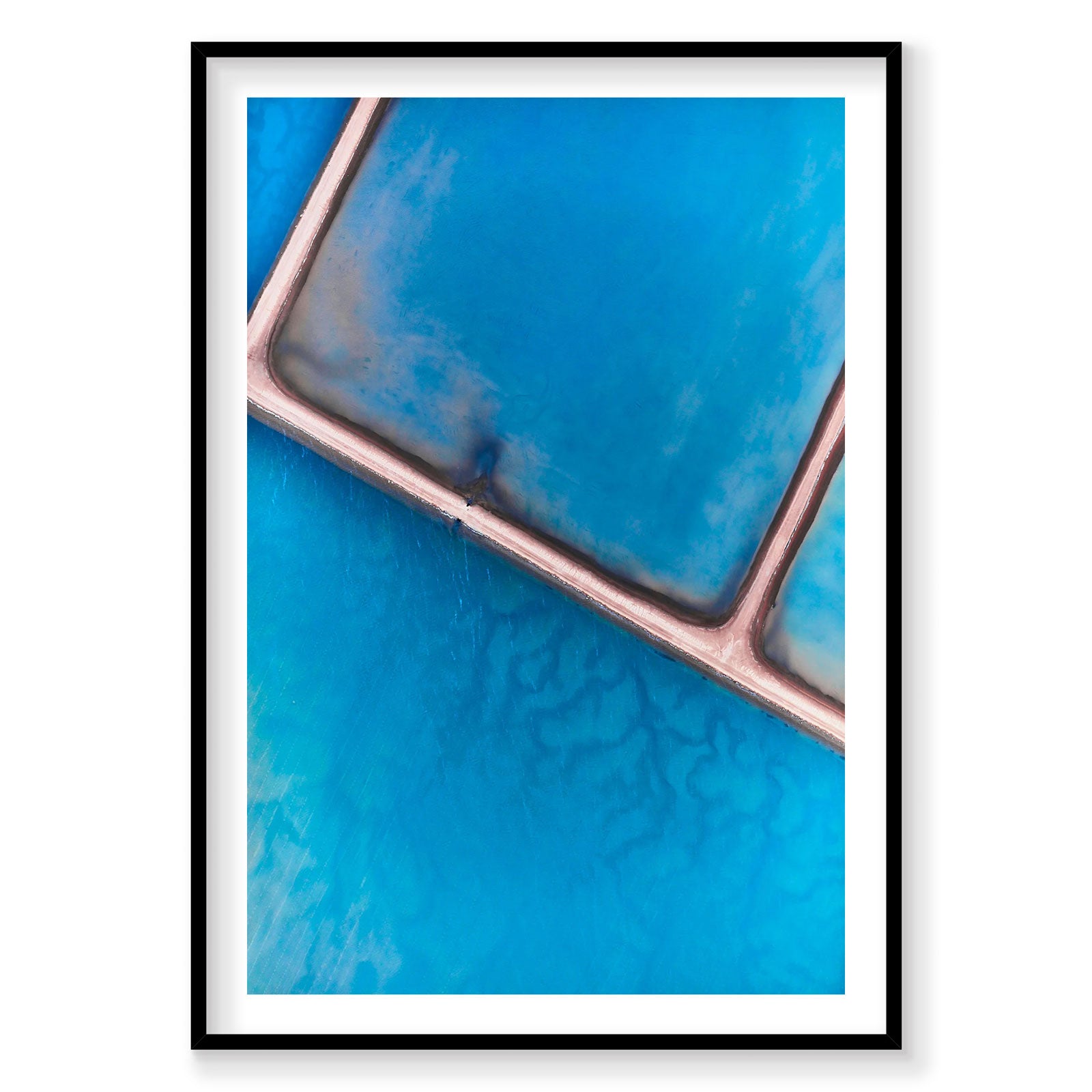 Aerial view of pink salt pond causeway on turquoise water from above, photography print by Remy Gerega