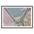 Aerial view of pink and blue waters at Great Salt Lake with winding road, photography print by Remy Gerega