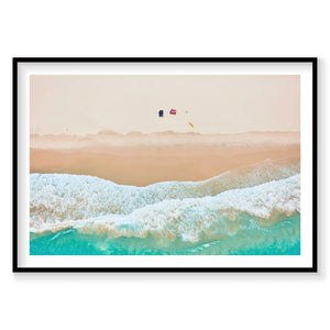 Aerial view of Byron Bay beach with turquoise waves, white foam, and colorful kites, photography print by Remy Gerega
