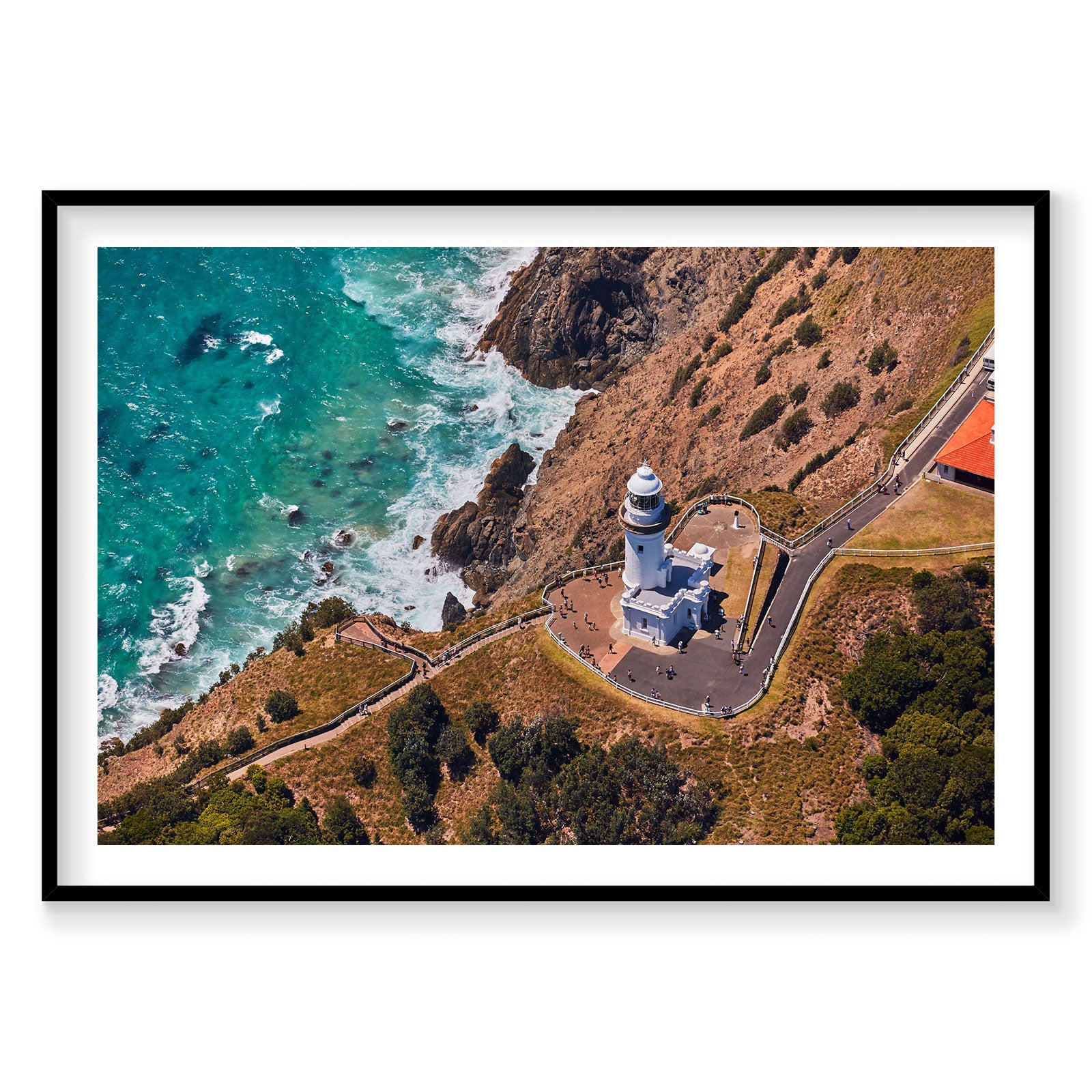 Aerial view of Byron Bay Lighthouse on clifftop with turquoise ocean below, photography print by Remy Gerega