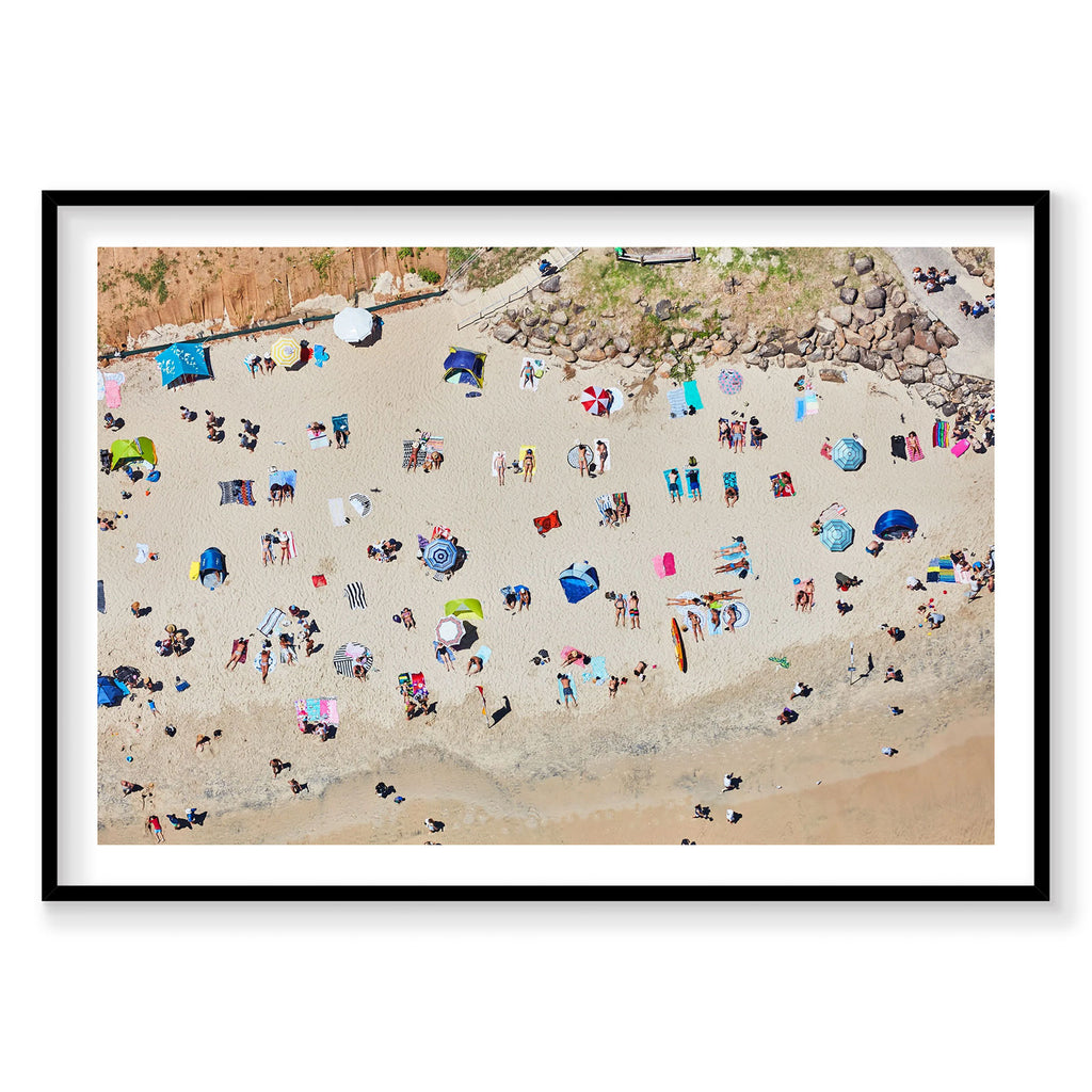 Aerial view of Byron Bay beach with colorful umbrellas and sunbathers scattered on sand, photography print by Remy Gerega