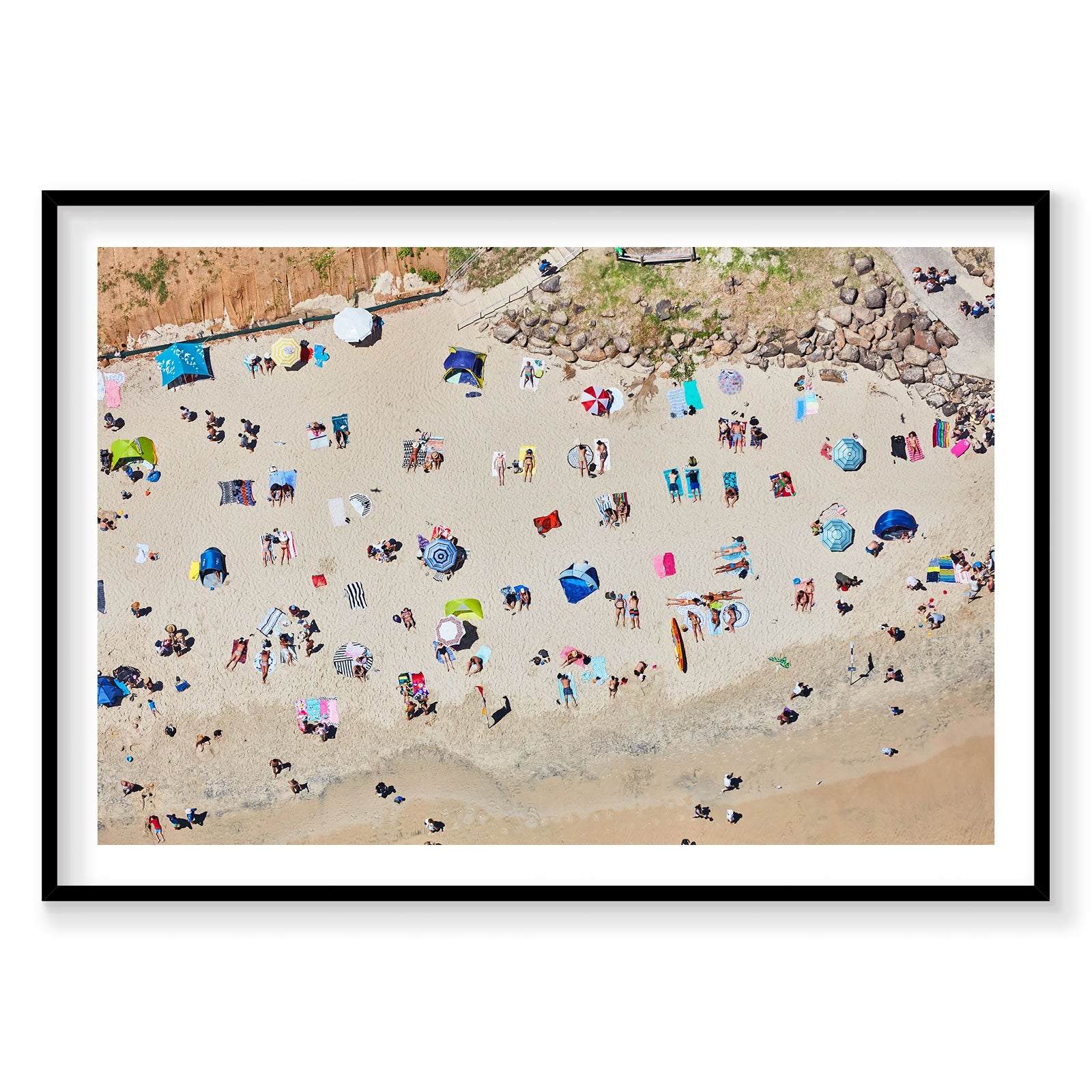 Aerial view of Byron Bay beach with colorful umbrellas and sunbathers scattered on sand, photography print by Remy Gerega