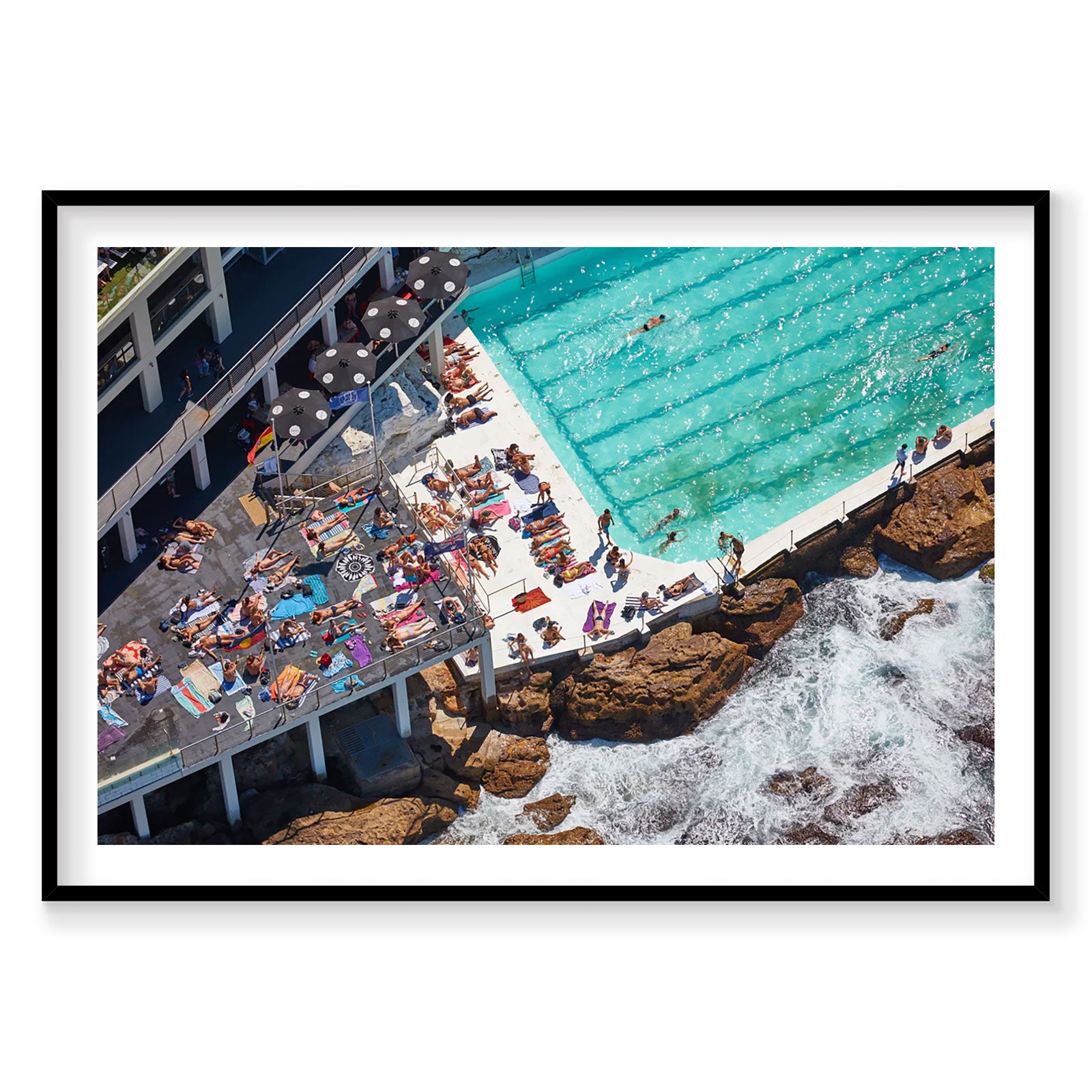 Aerial view of Bondi Icebergs pool with turquoise water and sunbathers on surrounding rocks, photography print by Remy Gerega
