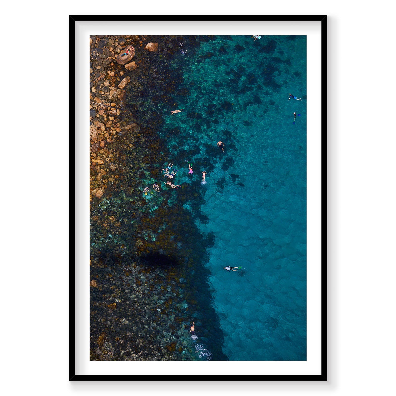 Aerial view of snorkelers at Cabbage Tree Bay rocky coastline and turquoise water, photography print by Remy Gerega