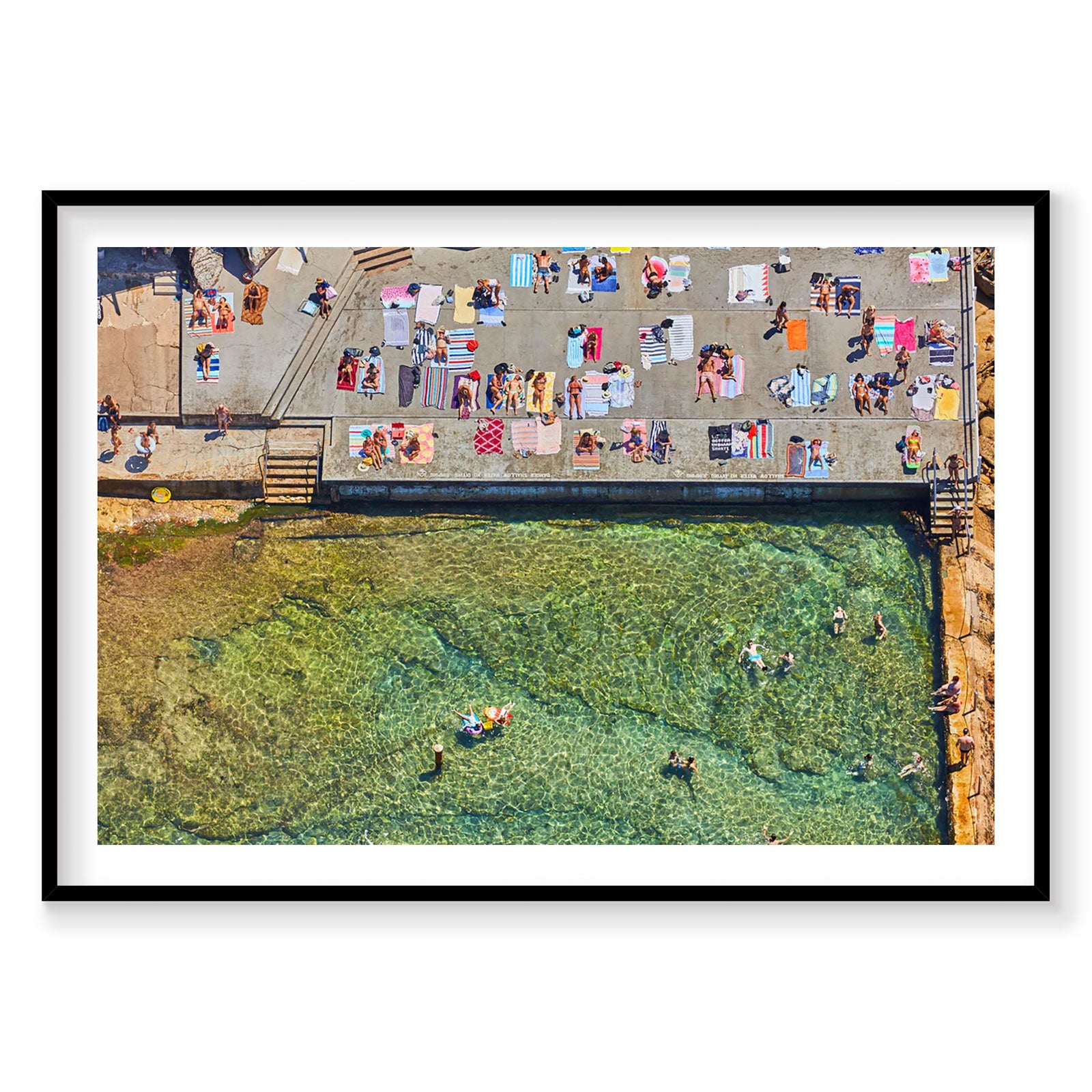 Aerial view of Wylie's Baths ocean pool with turquoise water and sunbathers on concrete deck, photography print by Remy Ge...