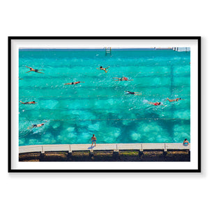 Aerial view of swimmers in turquoise ocean pool with spectators on deck, photography print by Remy Gerega