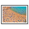 Aerial view of Shelly Beach crowded with colorful umbrellas and swimmers in turquoise water, photography print by Remy Gerega
