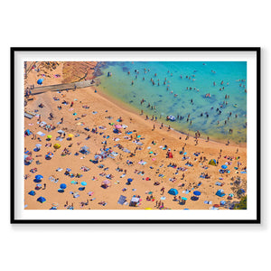 Aerial view of Shelly Beach crowded with colorful umbrellas and swimmers in turquoise water, photography print by Remy Gerega