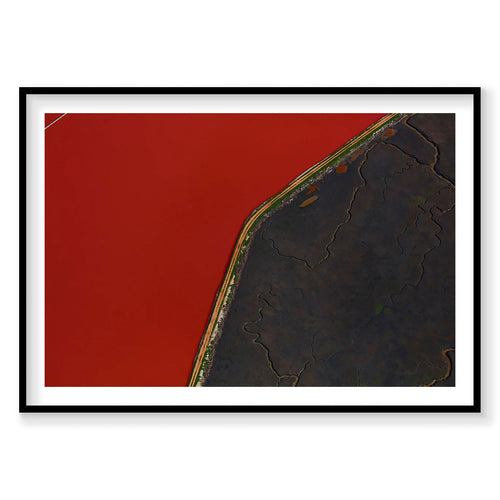 Aerial view of San Francisco Bay with red water and dark shoreline, photography print by Remy Gerega