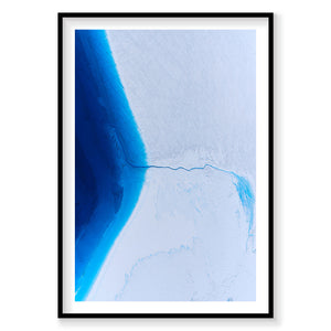 Aerial view of vibrant blue glacial ice sheet meeting white snow in Greenland from above, photography print by Remy Gerega