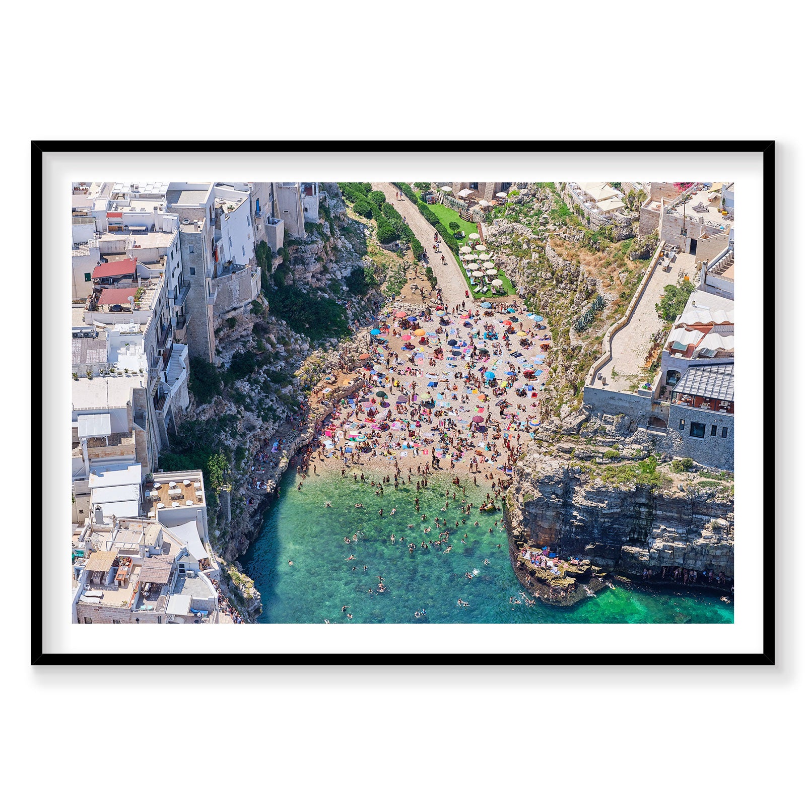 Aerial view of Polignano a Mare beach cove with turquoise water and crowded sandy beach, photography print by Remy Gerega