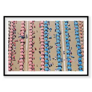 Aerial view of Italian beach with pink and blue umbrellas arranged in rows, photography print by Remy Gerega