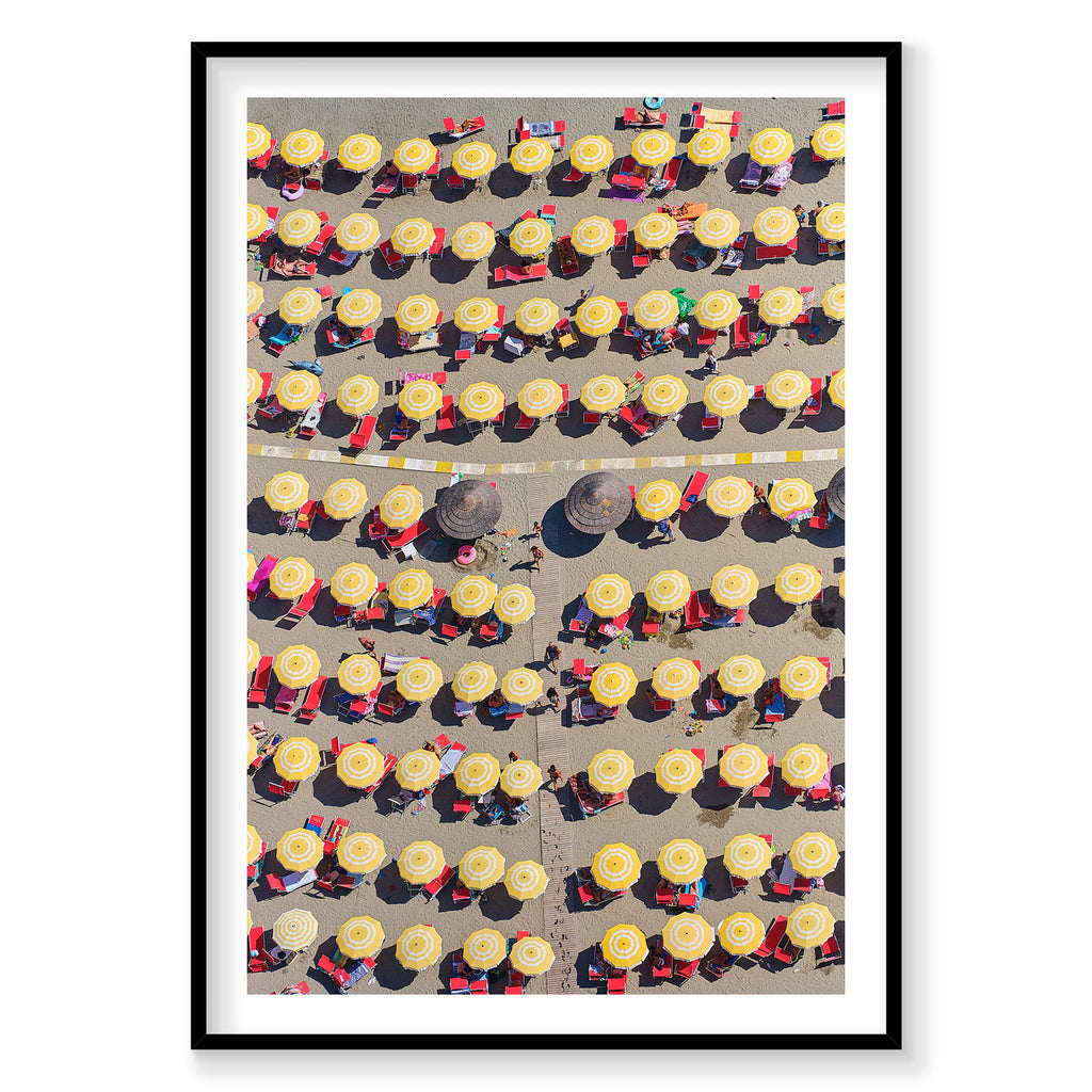 Aerial view of Italian beach with yellow umbrellas and red loungers from above, photography print by Remy Gerega