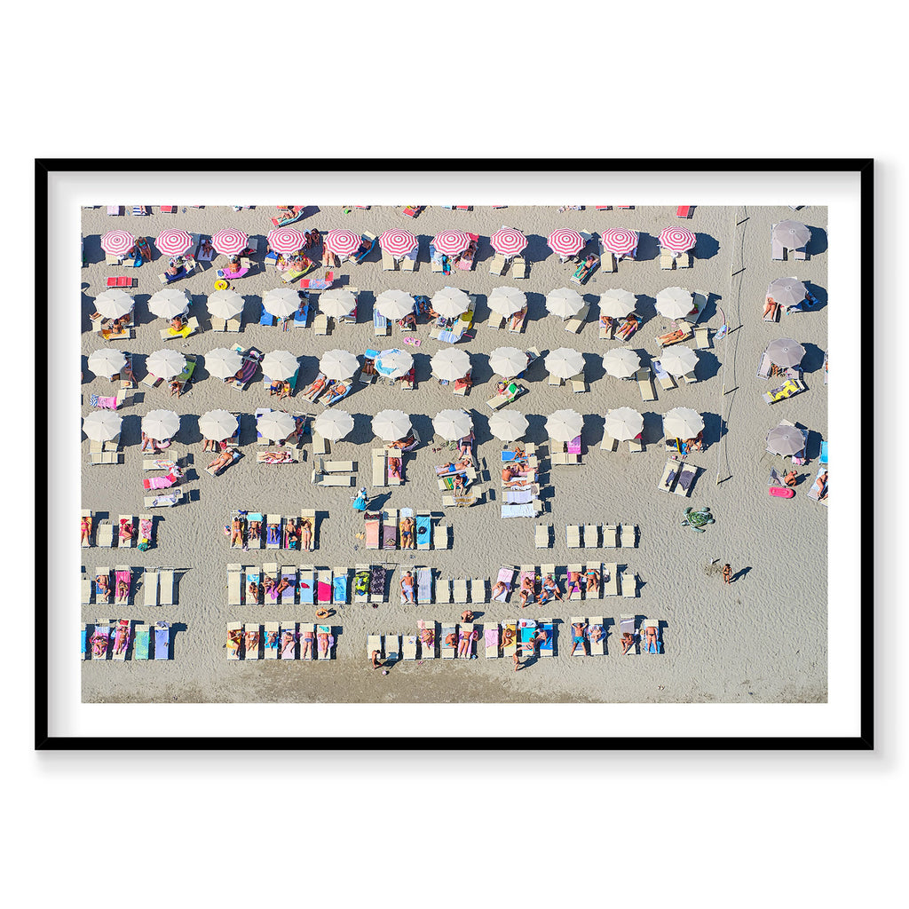 Aerial view of Italian beach with colorful umbrellas and sunbathers arranged in rows, photography print by Remy Gerega