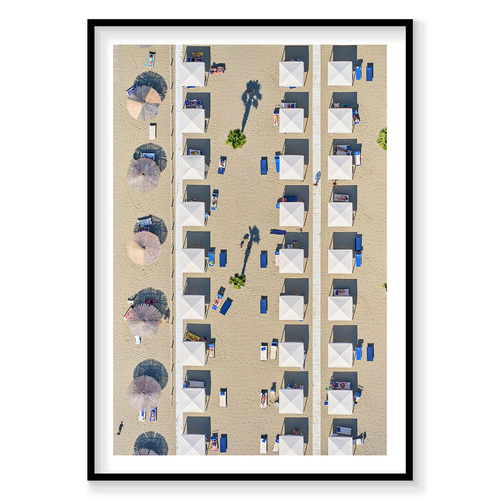 Aerial view of organized beach cabanas and umbrellas on sandy Italian shore, photography print by Remy Gerega
