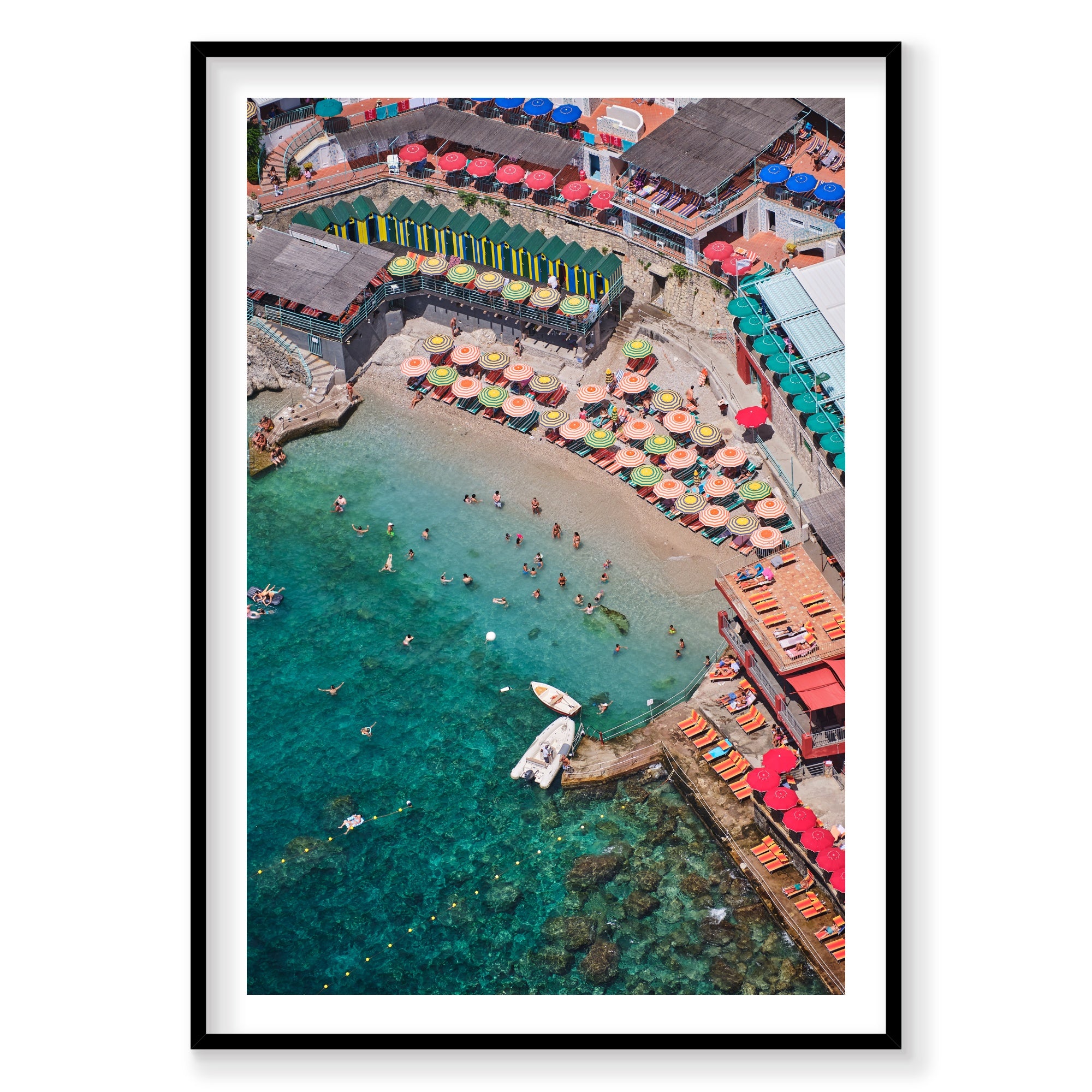 Aerial view of Bagni Internazionali Capri with colorful umbrellas and people in the water, framed artwork.
