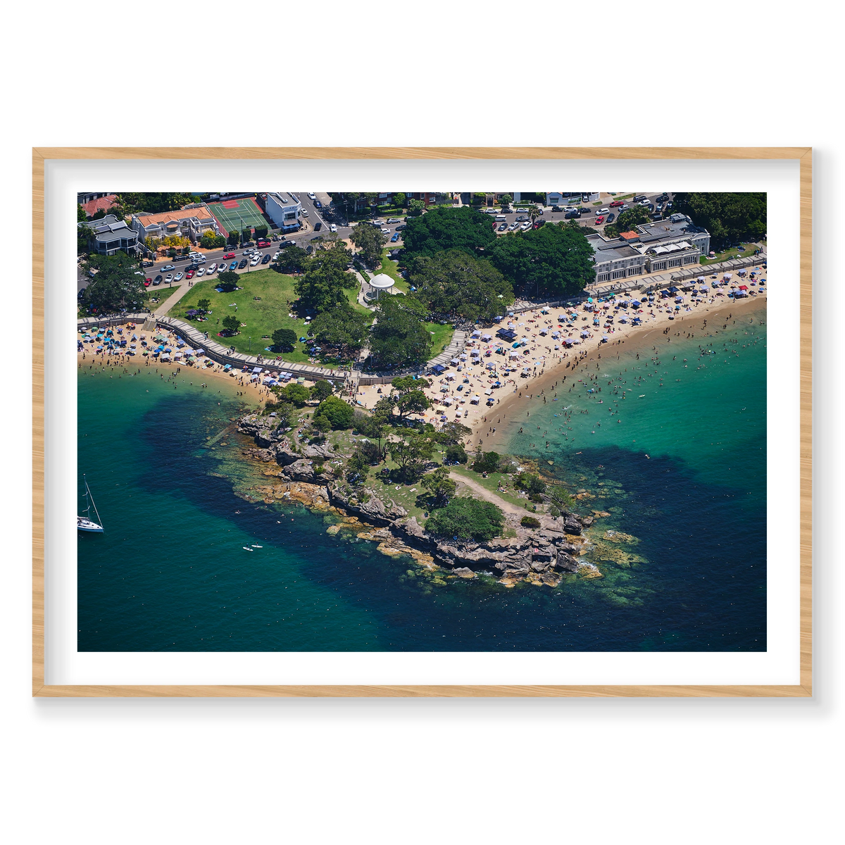 Balmoral Beach photograph with green shallows and a rocky point, shown in a natural timber frame.
