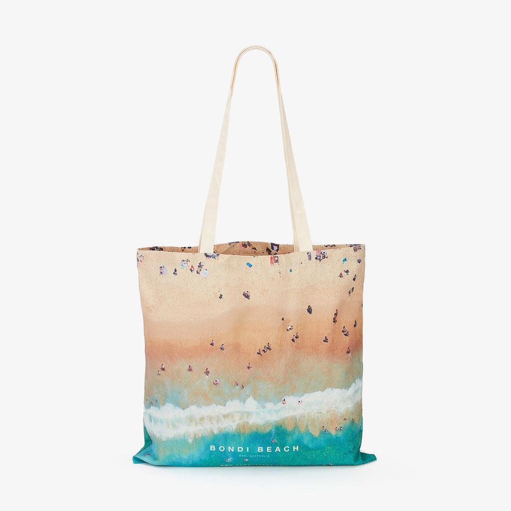 Aerial view of Bondi Beach with swimmers and waves, canvas tote bag by Remy Gerega