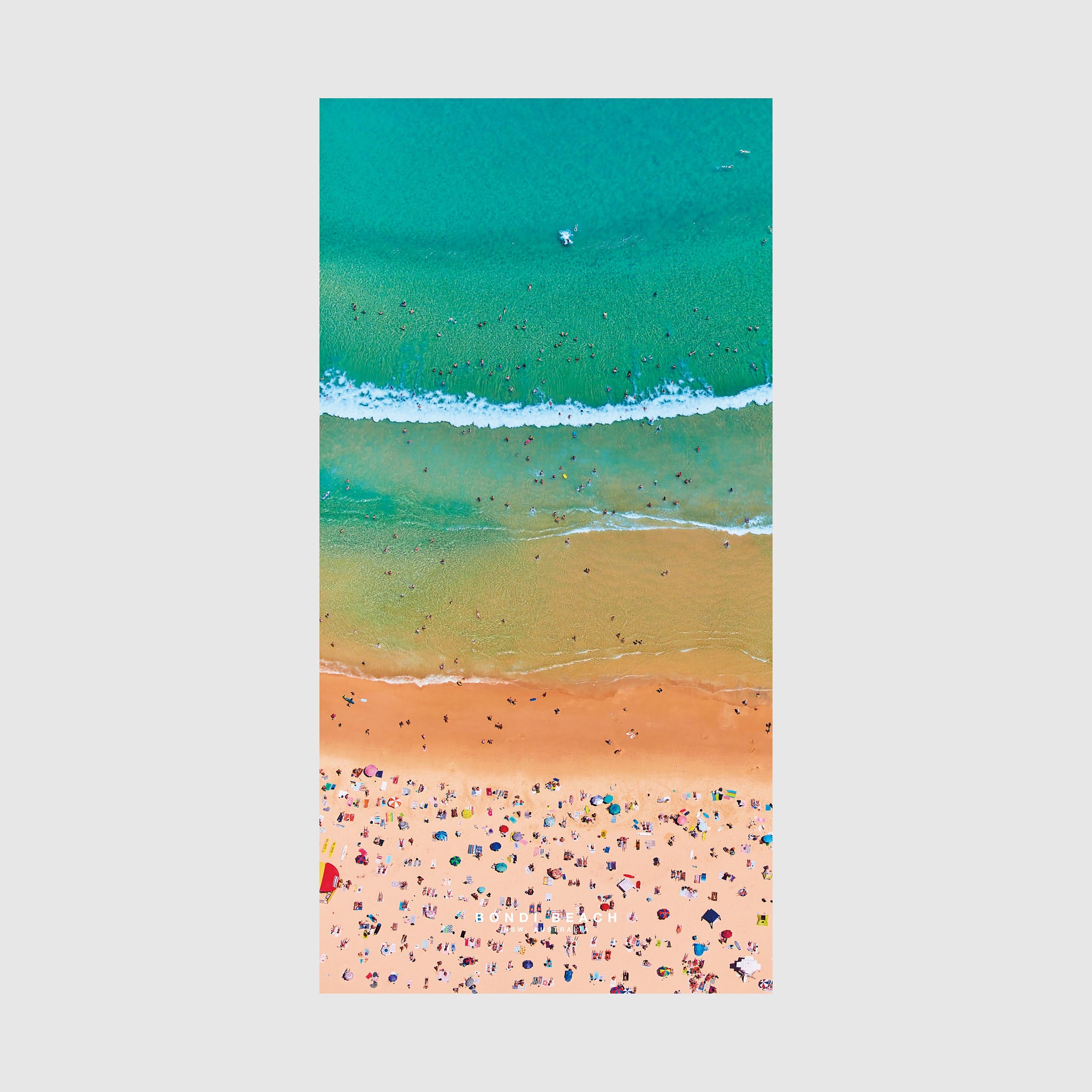 Aerial view of Bondi Beach with turquoise ocean, white waves, and colorful beach umbrellas, quick-dry beach towel by Remy Gerega