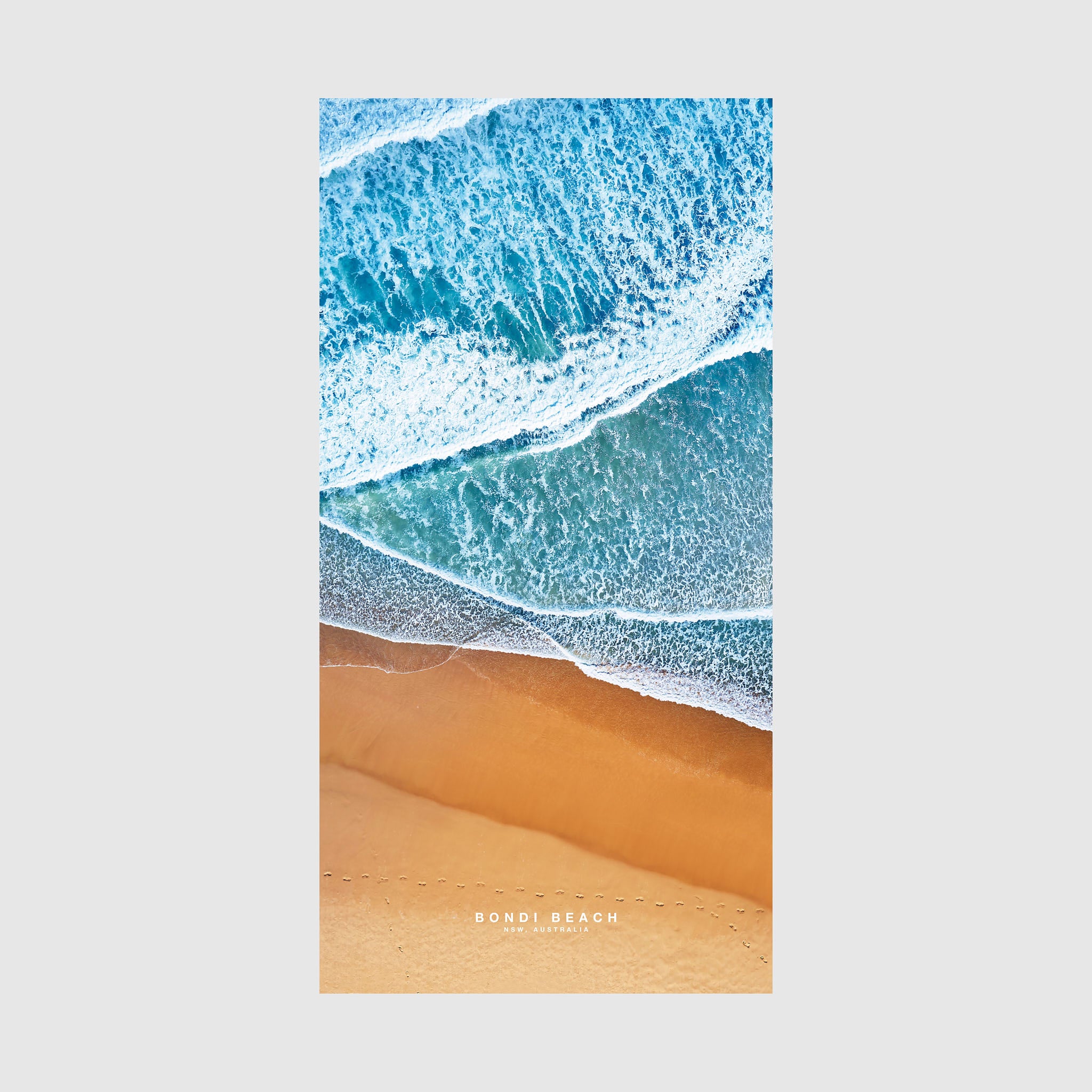 Aerial view of Bondi Beach shoreline with turquoise waves and golden sand, quick-dry beach towel by Remy Gerega