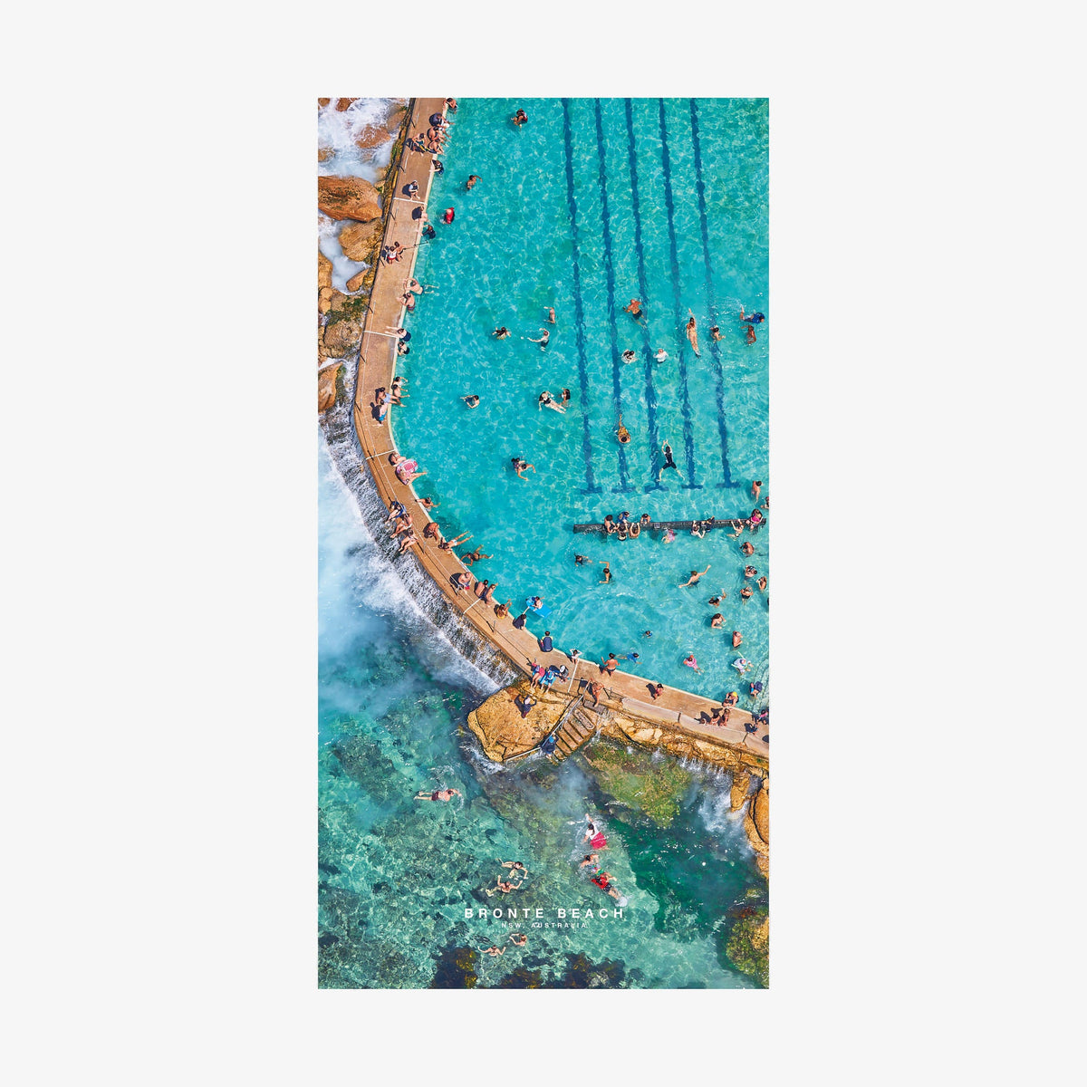 Aerial view of Bronte Beach ocean pool with turquoise water and swimmers, quick-dry beach towel by Remy Gerega