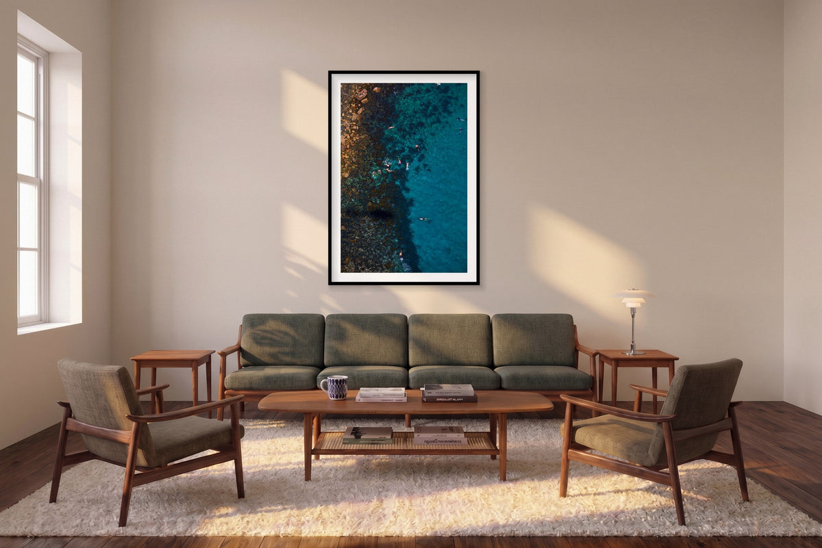 Cabbage Tree Bay Snorkelers, Vertical Print shown framed in a living room