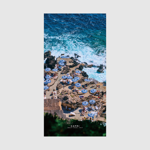 Aerial view of Capri beach cove with blue umbrellas and turquoise waves, Amalfi Coast Italy, quick-dry beach towel by Remy Gerega