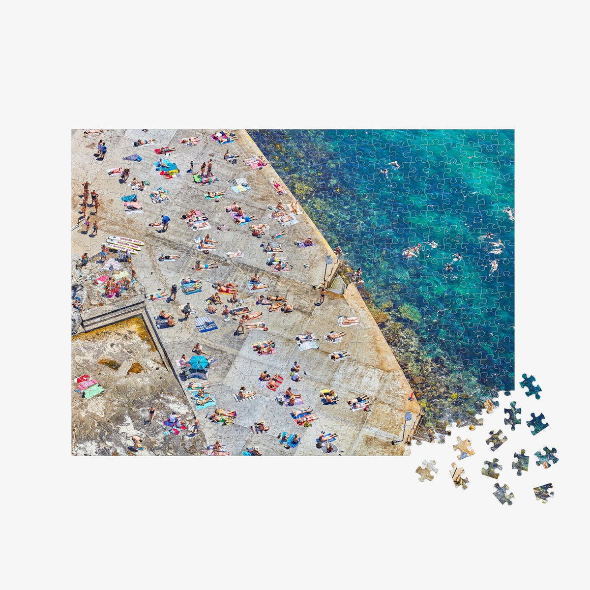 Aerial view of Clovelly Beach with sunbathers and turquoise water from above, 500 piece jigsaw puzzle by Remy Gerega