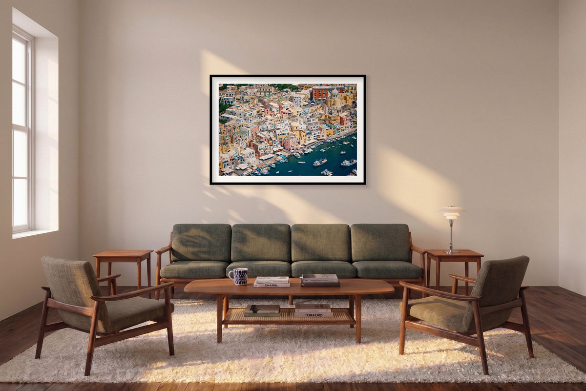 Colourful Neighbours, Procida horizontal photograph in a black frame above a sofa in the room mockup.