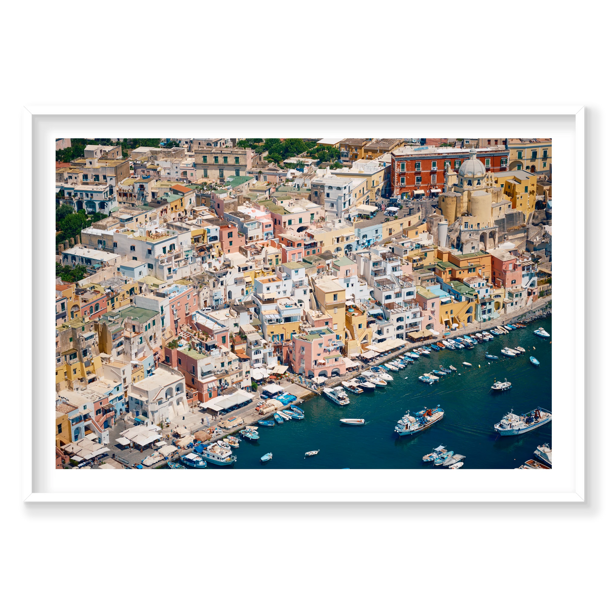 Pastel waterfront buildings, balconies and small boats on deep blue water in Procida, Italy, white frame.