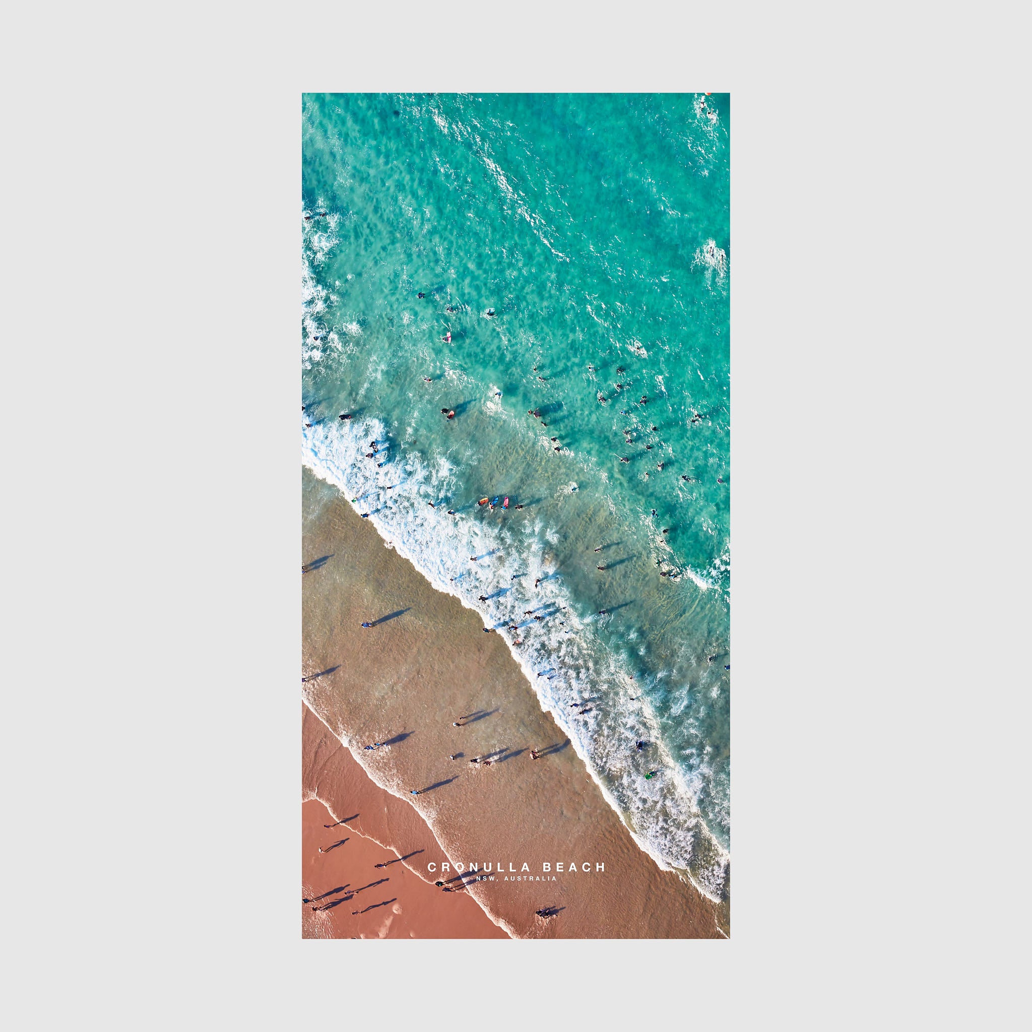 Aerial view of Cronulla Beach with turquoise water, white waves, and red sand, quick-dry beach towel by Remy Gerega