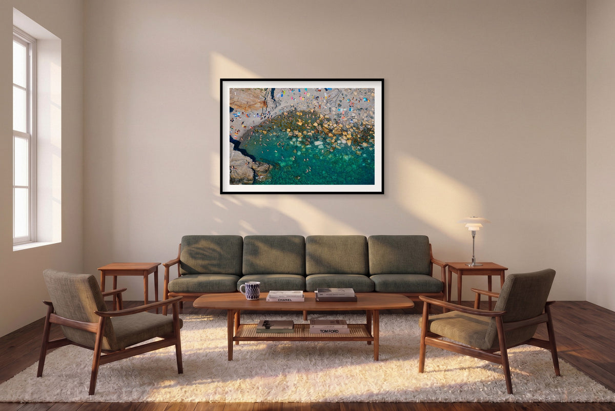 Find Your Spot, Vernazza horizontal photograph in a black frame above a sofa in the room mockup.