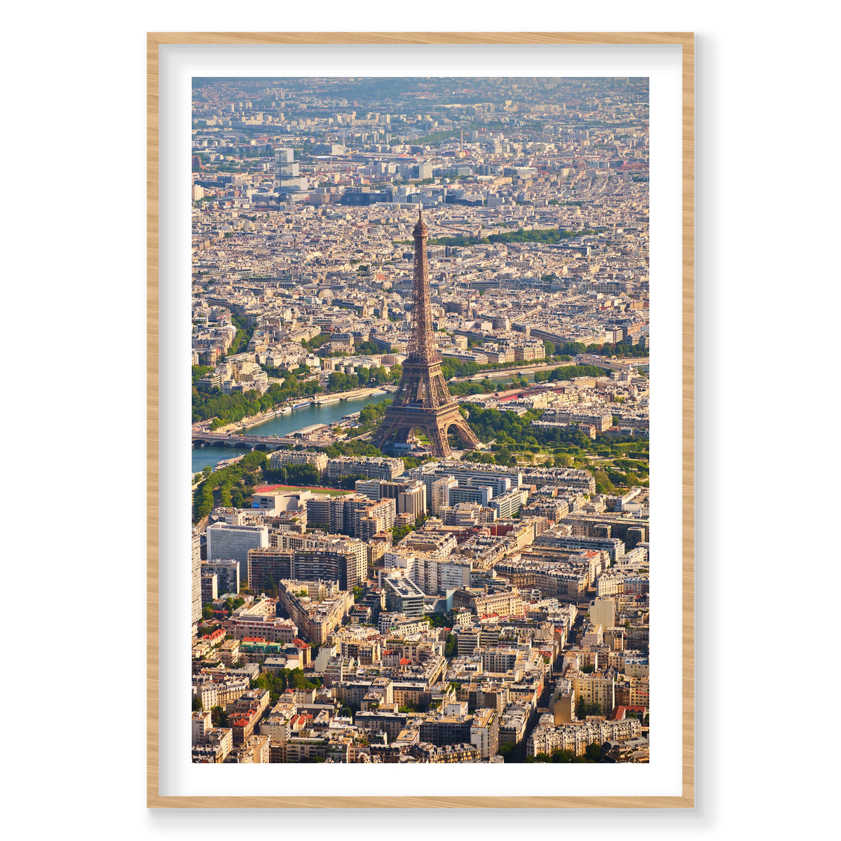 Vertical aerial photograph of the Eiffel Tower, the Seine and densely packed Paris rooftops extending into the distance; natural timber frame