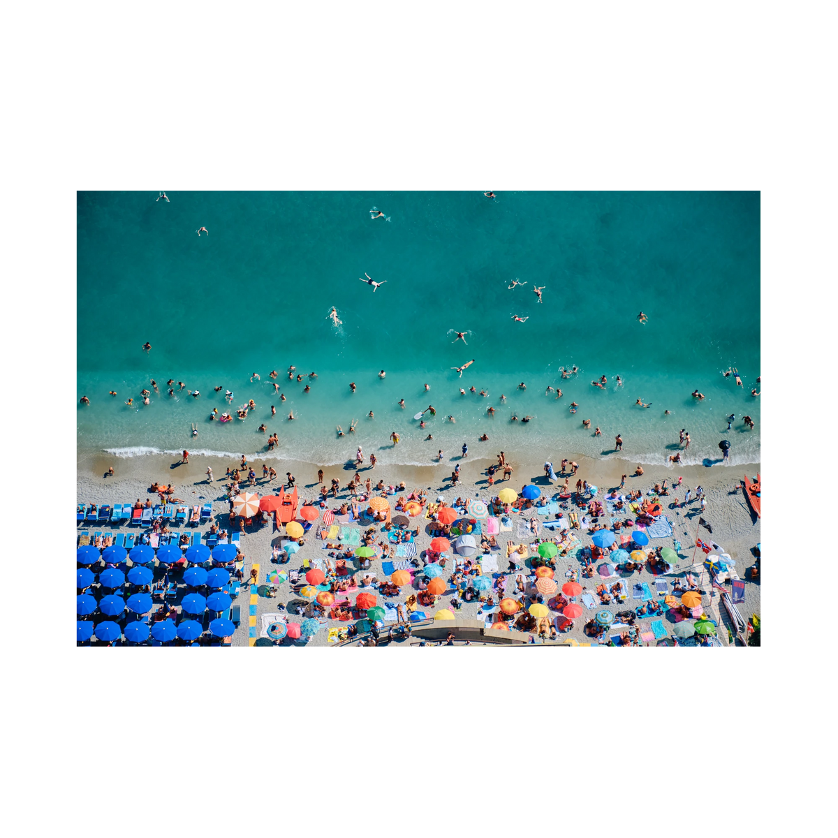 Swimmers in turquoise water beside colourful beach umbrellas at Monterosso al Mare, Cinque Terre, Italy, print-only presentation.