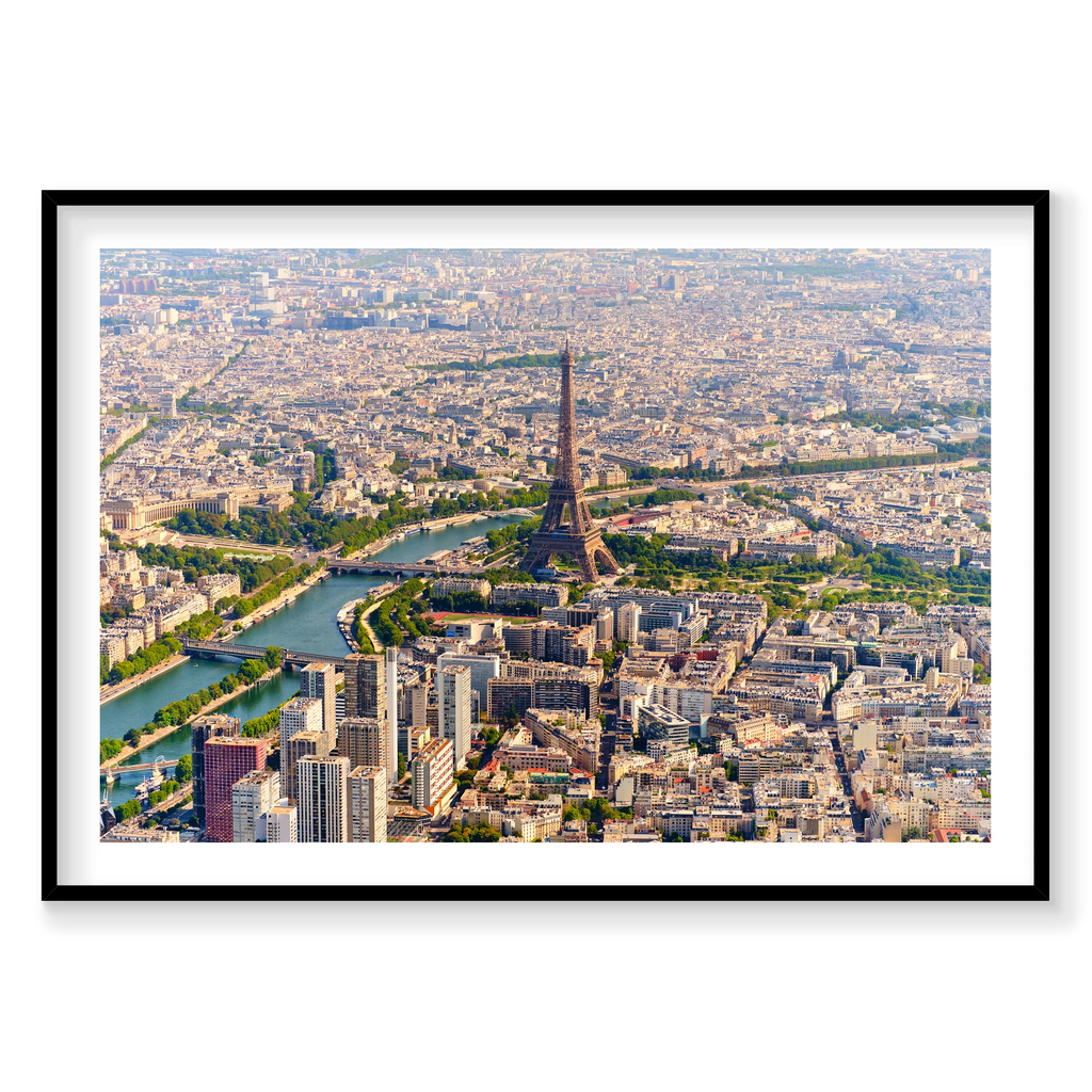 Wide aerial view of the Eiffel Tower, the Seine, bridges and surrounding Paris rooftops in daylight; black frame
