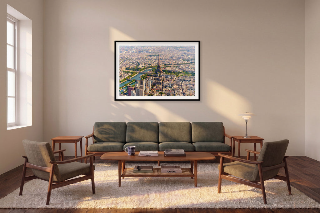 Wide aerial view of the Eiffel Tower, the Seine, bridges and surrounding Paris rooftops in daylight; black framed print in a room setting