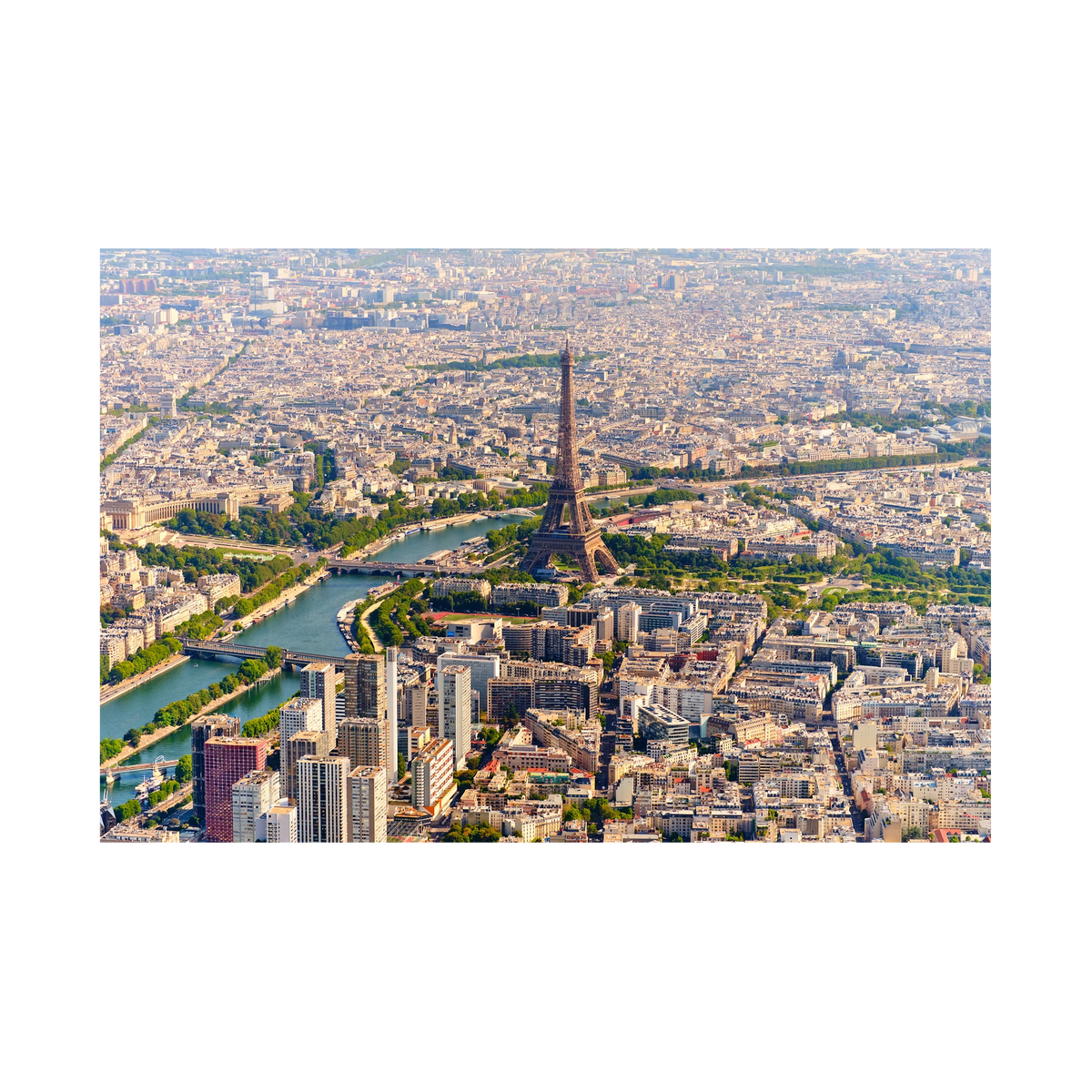 Wide aerial view of the Eiffel Tower, the Seine, bridges and surrounding Paris rooftops in daylight; print only