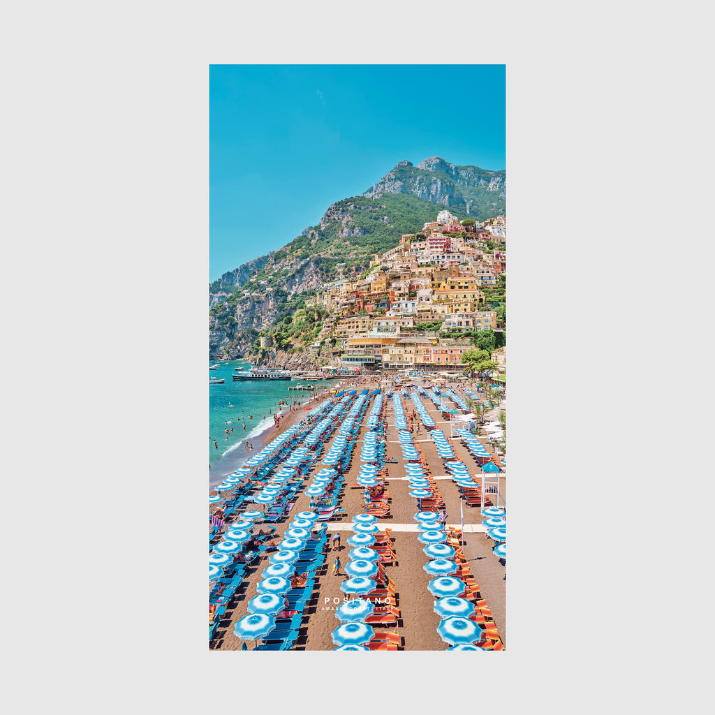 Positano beach with blue umbrellas and colorful cliffside village, Amalfi Coast Italy, quick-dry beach towel by Remy Gerega