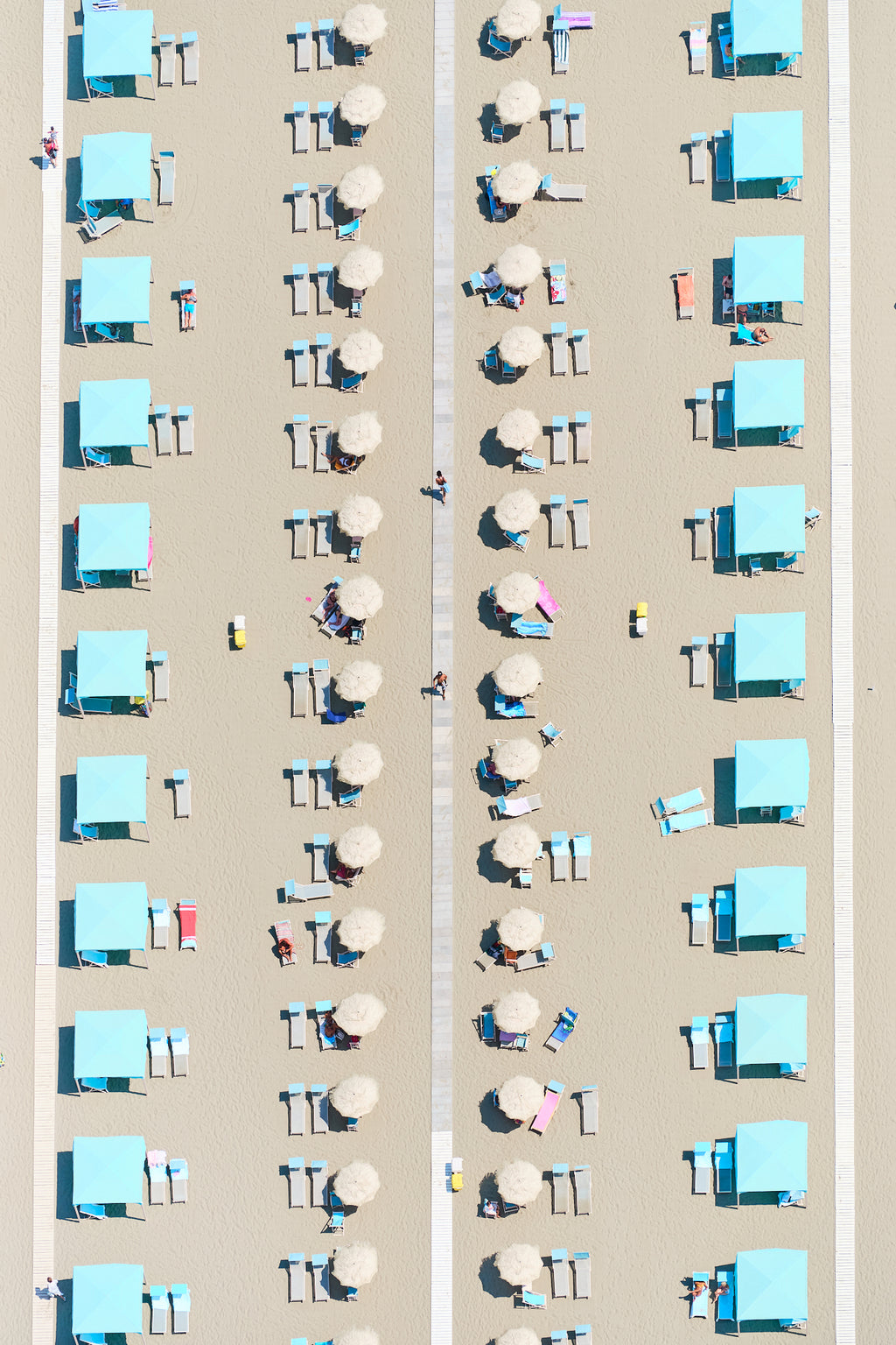 Rows of turquoise cabanas, pale umbrellas and sunloungers on the sand at Viareggio, Tuscany, Italy, print-only presentation.