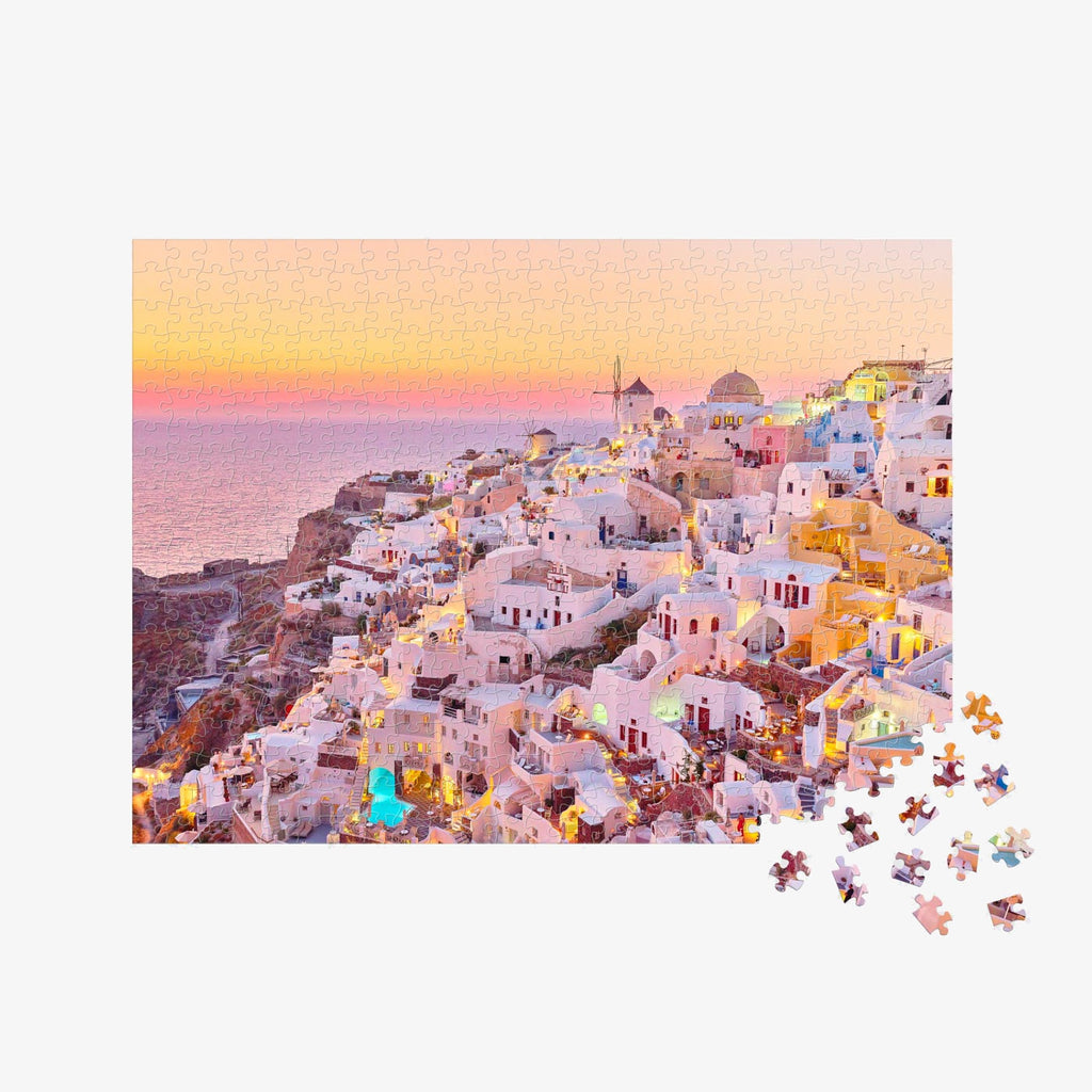 Santorini village at sunset with white-washed buildings and golden lights, 500 piece jigsaw puzzle by Remy Gerega