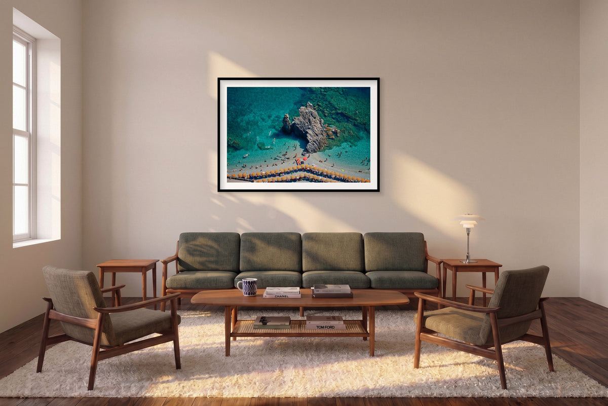 Scoglio di Fegina, Monterosso al Mare horizontal photograph in a black frame above a sofa in the room mockup.
