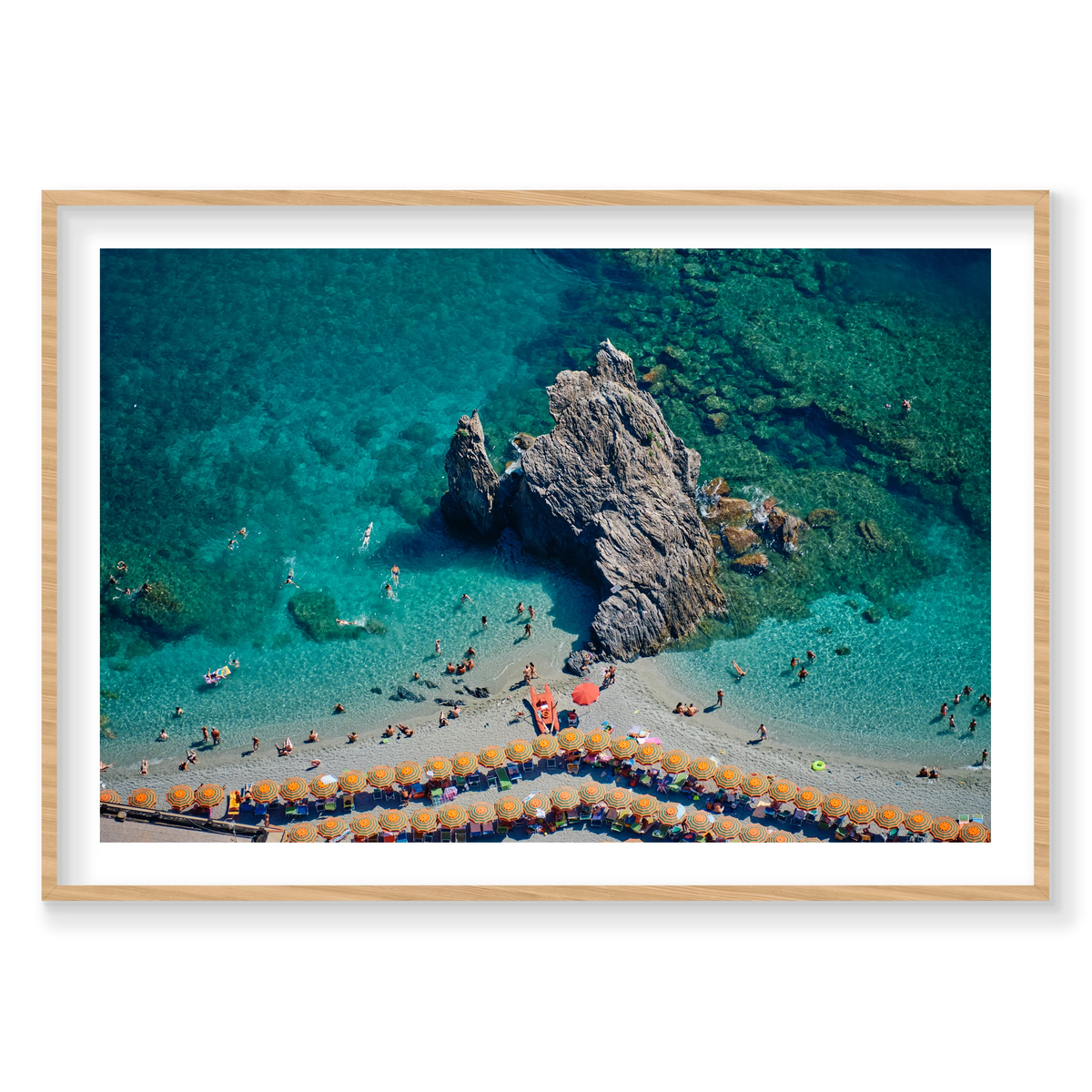 Scoglio di Fegina rock surrounded by swimmers and turquoise water, with orange-striped umbrellas at Monterosso al Mare, Cinque Terre, Italy, natural timber frame.