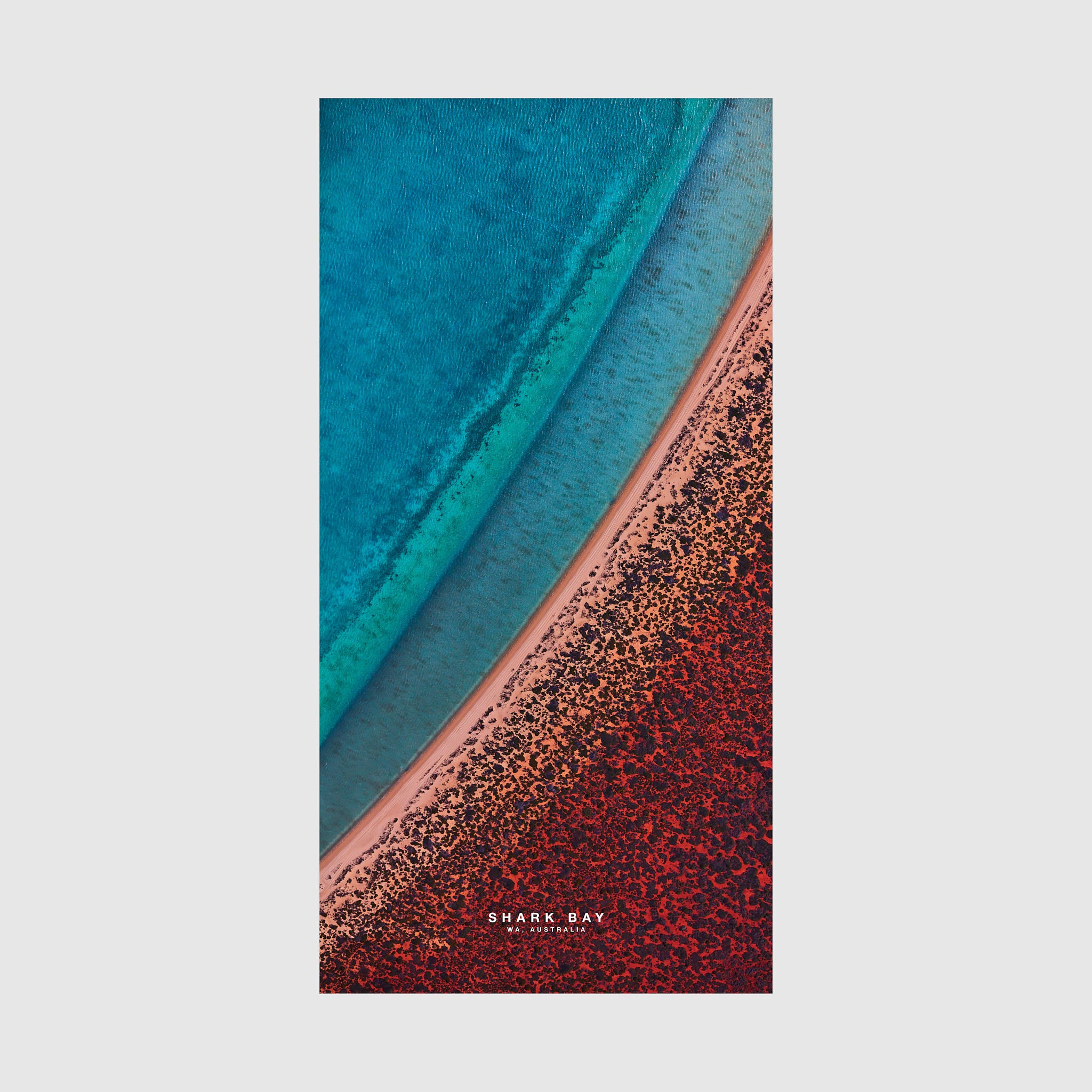 Aerial view of Shark Bay Western Australia with turquoise water and red algae-covered shoreline, quick-dry beach towel by Remy Gerega