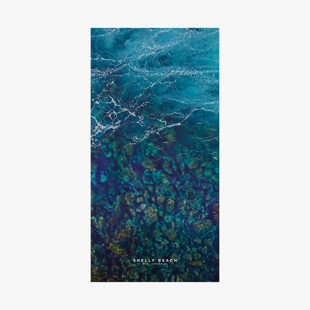 Aerial view of Shelly Beach NSW showing turquoise water and rocky reef formations from above, quick-dry beach towel by Remy Gerega