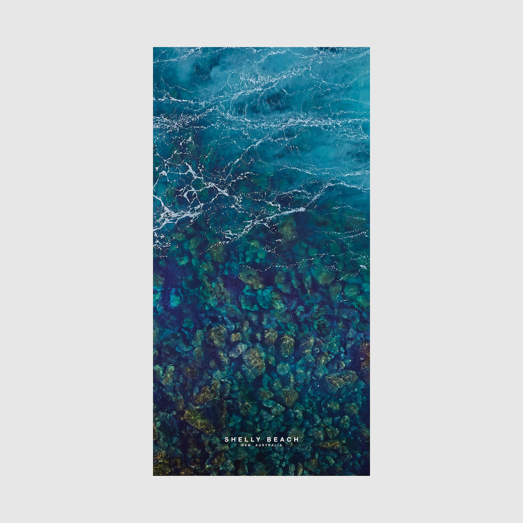 Aerial view of Shelly Beach NSW showing turquoise water and rocky reef formations from above, quick-dry beach towel by Remy Gerega