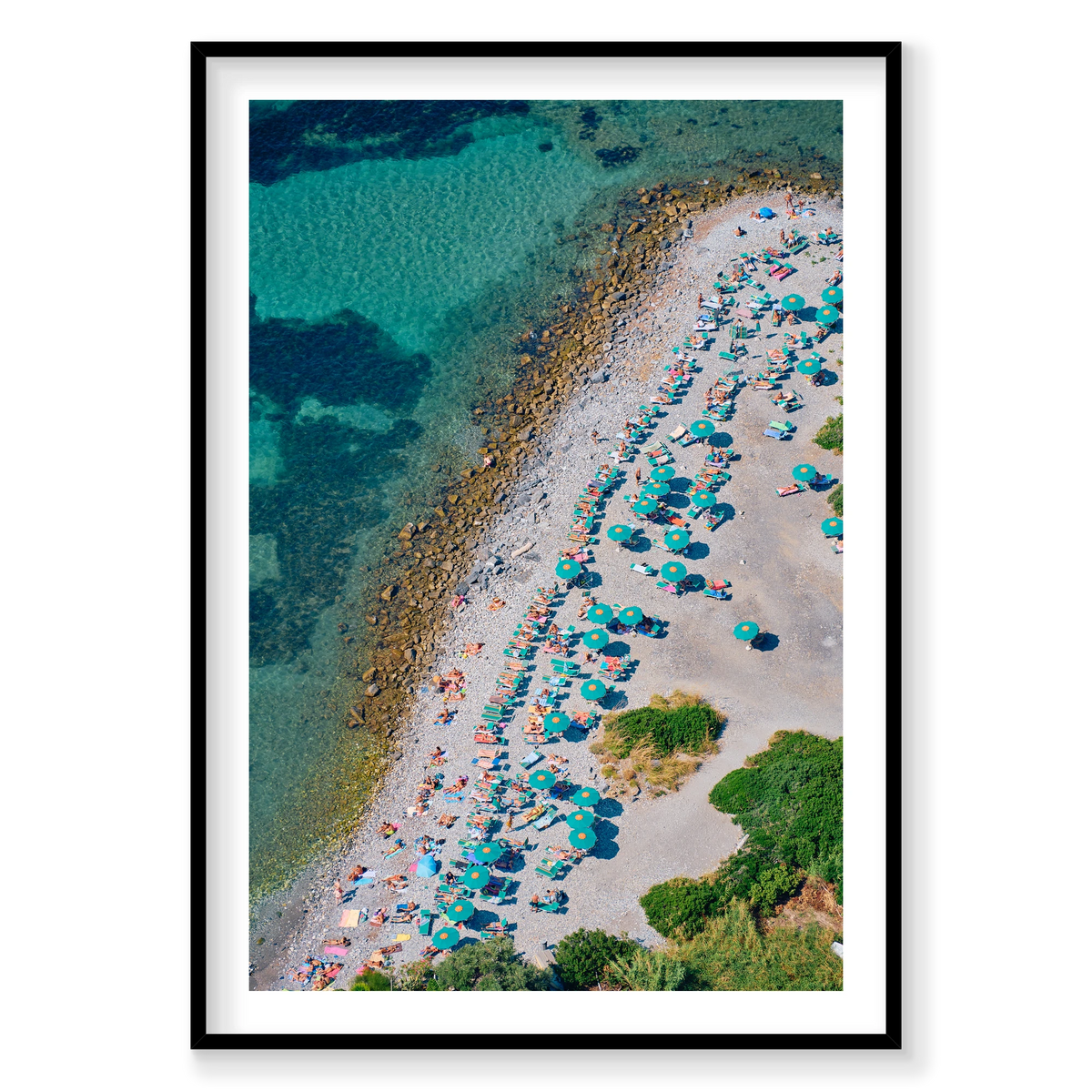 Green umbrellas and sunloungers beside clear water on the pebbled shore of Spiaggia Punta Secco, Palmaria Island, Italy, black frame.