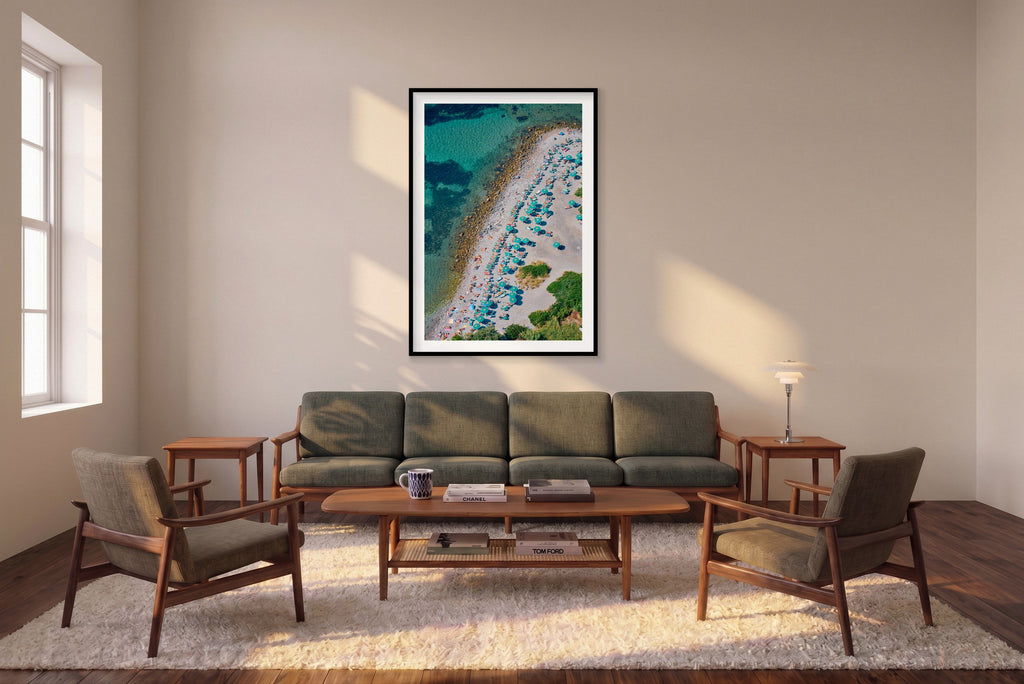 Spiaggia Punta Secco, Palmaria vertical photograph in a black frame above a sofa in the room mockup.