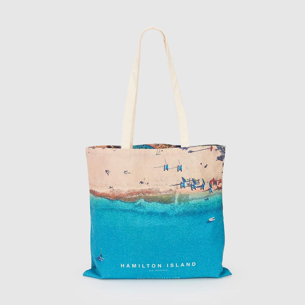 Aerial view of Hamilton Island beach with turquoise water and sandy shore, canvas tote bag by Remy Gerega